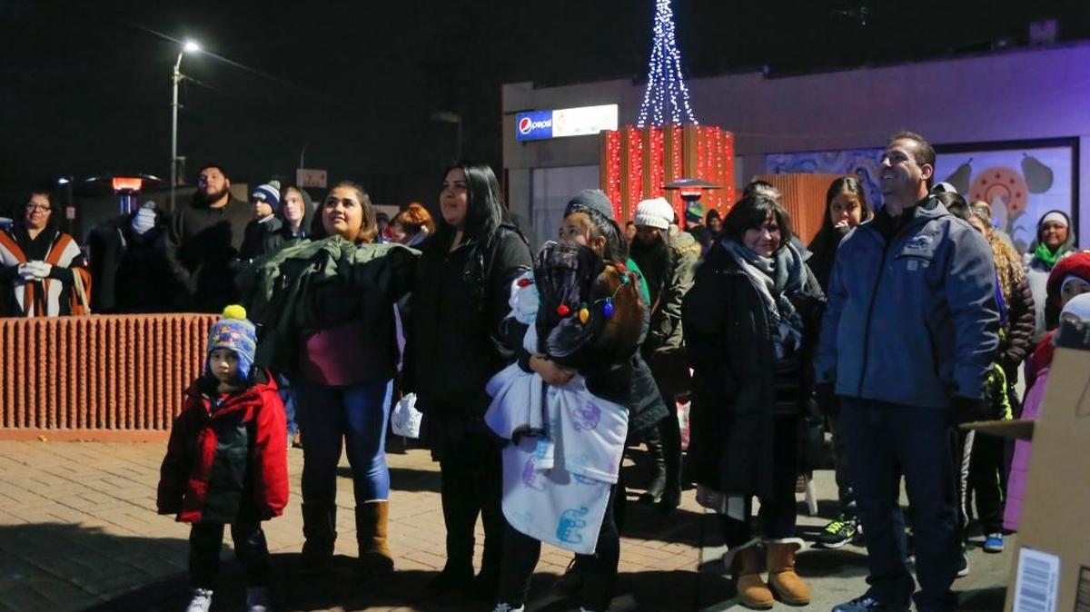 People gather in downtown Pasco on Saturday night to celebrate Christmas en la Plaza, an event put on by Downtown Pasco Development Authority (DPDA). The event began with a lighting and decorating ceremony along with music, food and a special visit from Santa and Ana from Disney's “Frozen.”