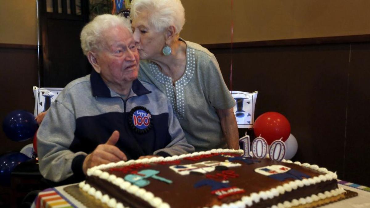 
Norman “Cap” Eckert of Richland gets a kiss from his wife of 66 years, Donna Mae on Wednesday as they celebrate his 100th birthday with friends and family in Richland. The couple moved to the Tri-Cities from Colorado in 1952. He retired from a career as a mail carrier in 1980 after 28 years with the Postal Service.
