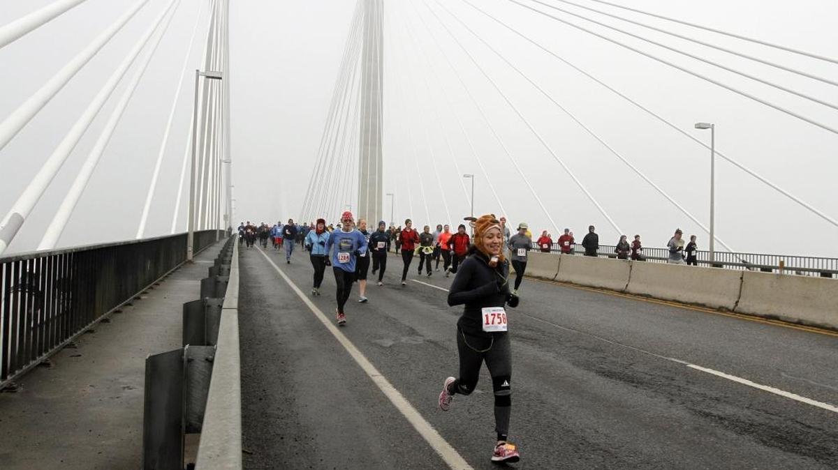 A runner in a reindeer hat crosses the Columbia River Saturday during the annual Lampson Cable Bridge Run. Almost 1,000 runners participated in the annual holiday 1 mile, 5k and 10k races. See more photos at www.tricityherald.com.