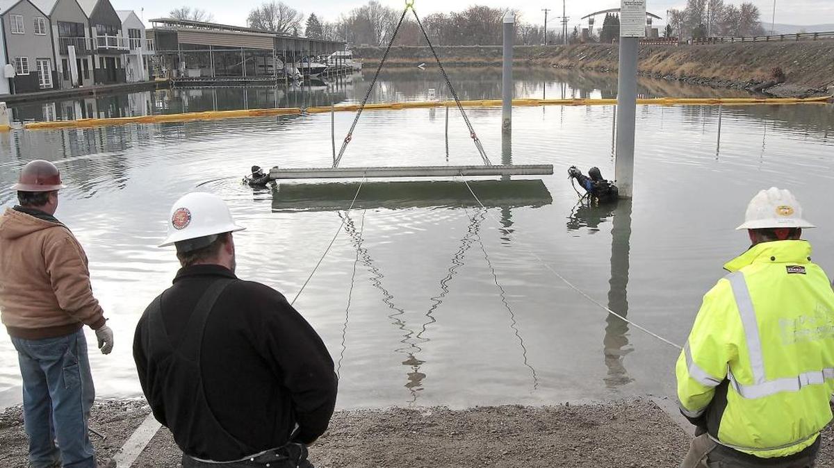 Divers Buddy Talbott, left, and Mark Allen of Allen Marine Services work together fitting into place pre-cast concrete boat ramp panels for the boat launch on Clover Island in Kennewick in this file photo. The overall cost of the project is just over $1 million.