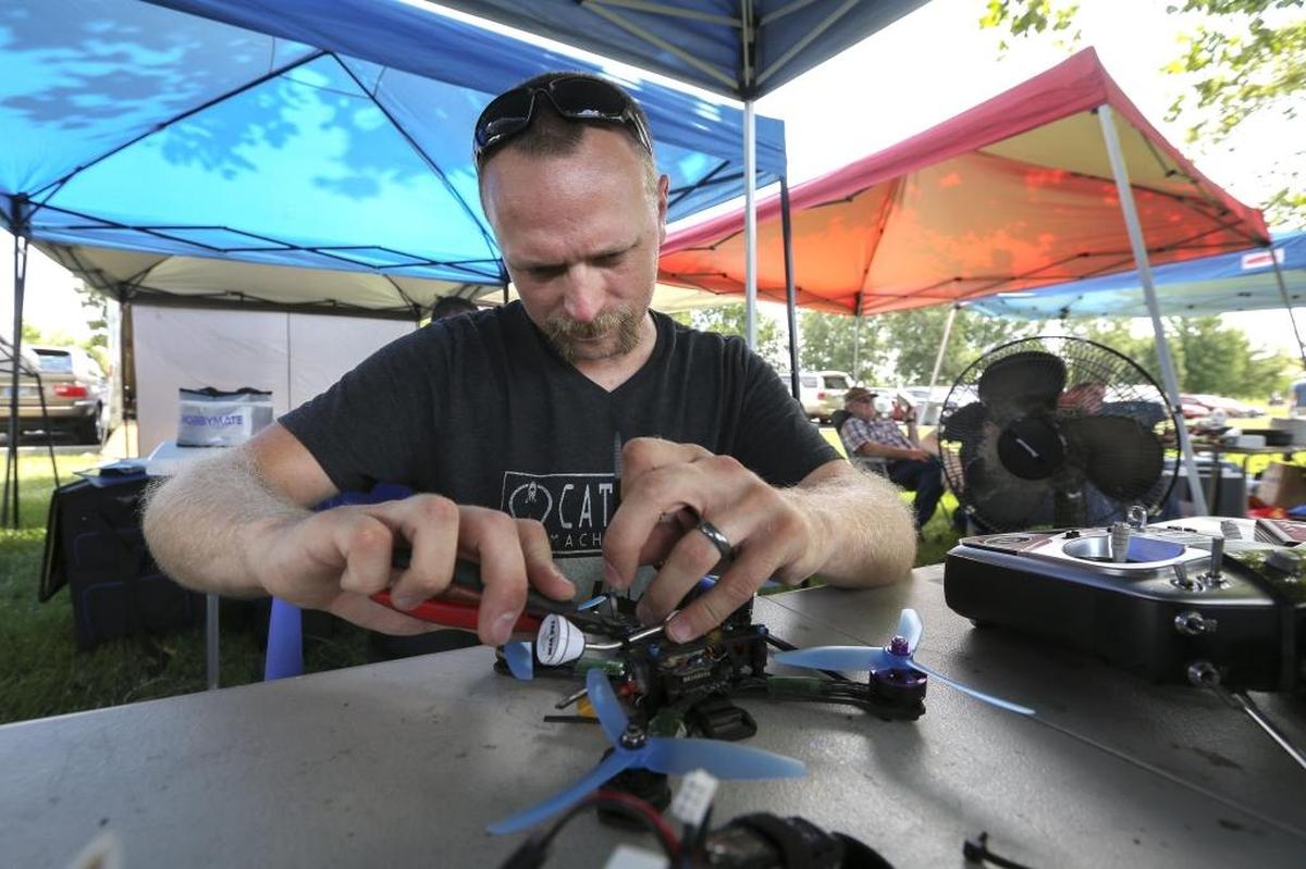 Ryan Evans works on his drone in between racing and a break during the MultiGP Great Northwest Regional Final at Columbia Park in Kennewick on Saturday. Evans traveled from Irving, Ore., to compete in the regional finals.