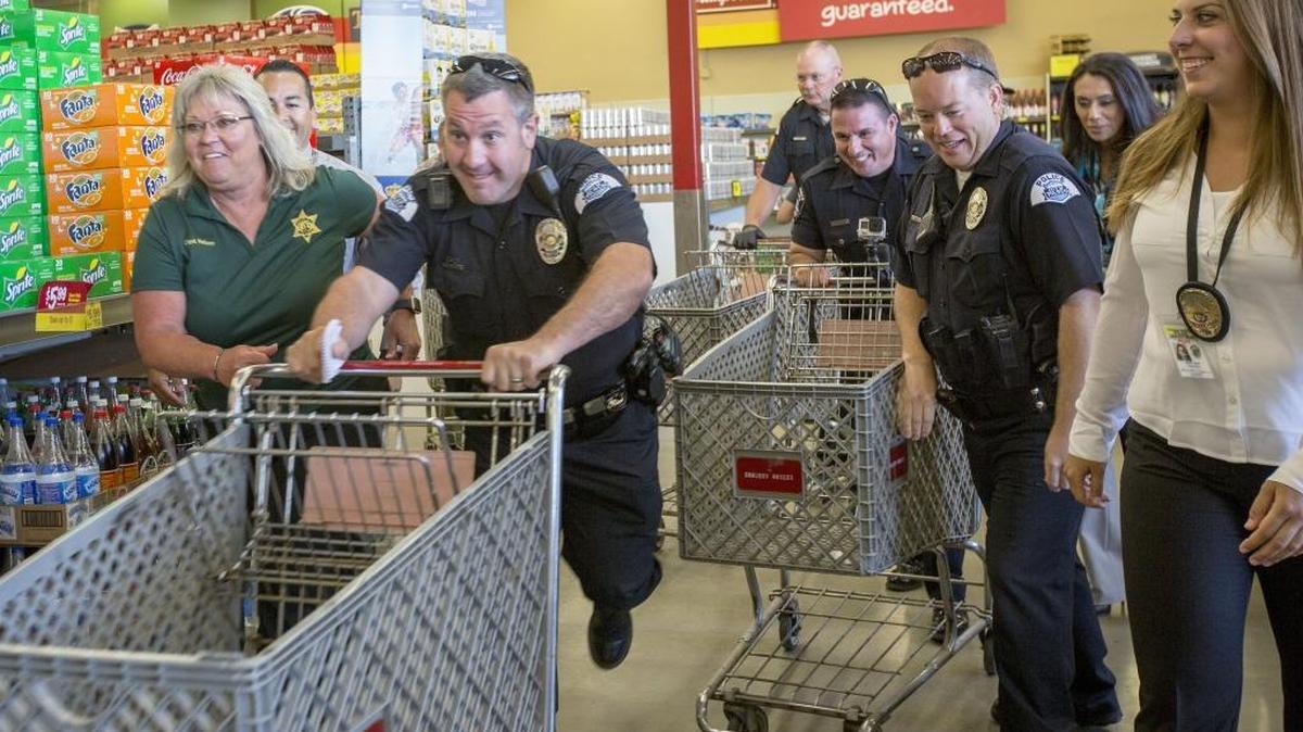 Kennewick police, Pasco police and firefighters and Franklin County Sheriff’s deputies race with grocery carts Tuesday in the “Battle of the Badge: Shopping Dash” at the Kennewick Grocery Outlet. Each team had two minutes to spend $250 on groceries to be donated to 2nd Harvest for the needy. The Franklin County team won. Watch the video at tricityherald.com/video.