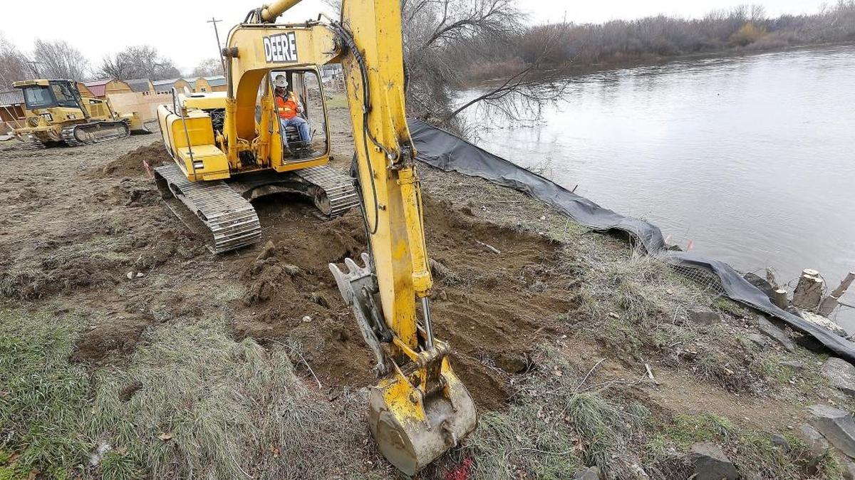 Workers remove soil and rocks Tuesday from next to the Van Giesen Street bridge over the Yakima River in West Richland. The work is part of the $2.1 million Yakima River Gateway project by the city of West Richland.