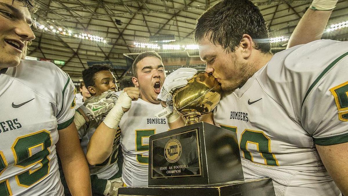 December 4, 2017 - Richland lineman Jacobe Lee (50) kisses the trophy as the Bombers celebrate winning the WIAA 4A State Football Championship in the Tacoma Dome on Saturday.