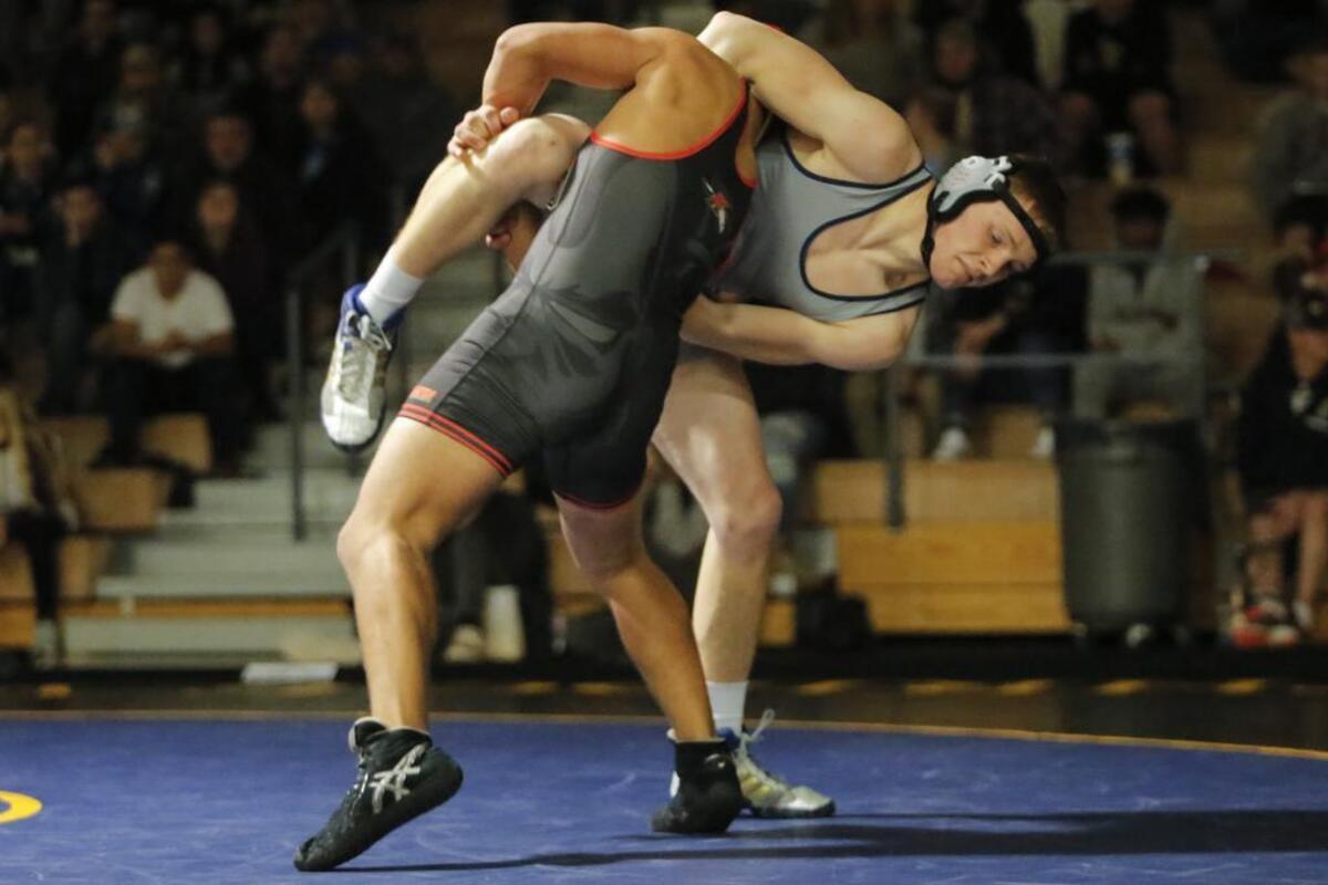 Kamiakin’s Gilbert Marquez (front) is a regional champion at 195 pounds in Class 3A.