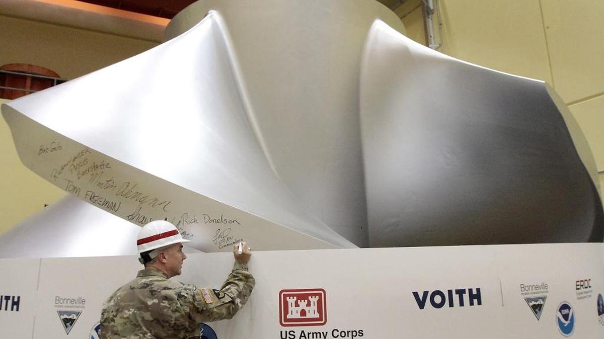 Lt. Col. Timothy Vail, then commander of the Walla Walla District of the Army Corps of Engineers, signs a new fish-friendly and high efficiency turbine at Ice Harbor Dam on the Snake River in 2016.