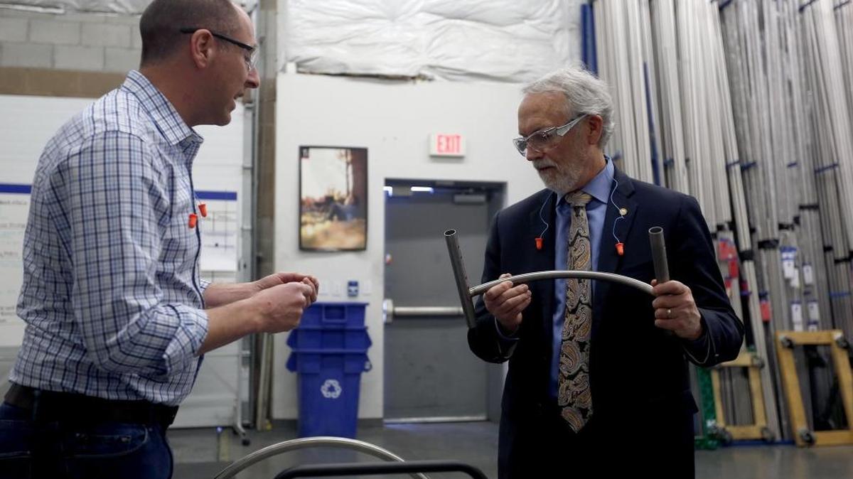 Rep. Dan Newhouse, right, and TiLite Vice President of Engineering Peter Archambault look at a piece for a wheelchair Wednesday during a tour of the company’s facility in Pasco. The congressman visited several businesses in the region this week. TiLite designs and manufactures customizable titanium and aluminum wheelchairs. See a video at www.tricityherald.com/video.