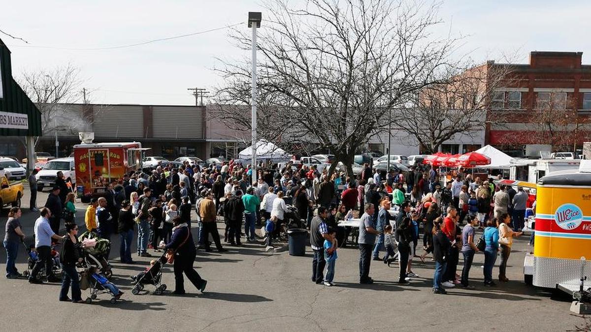 A large group gathered in the Pasco Farmers Market for the debut of Food Truck Friday in March 2015. The popular weekly event returns April 1 to the farmers market.