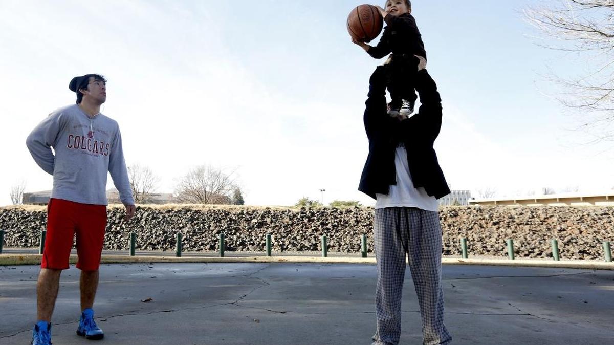 Levi Jones of Pasco holds up his son Evan Pena, 3, to shoot a basket Thursday while cousin Hunter Walsh watches as they take advantage of the nicer weather at the basketball court at Howard Amon Park in Richland. The nice weather is short lived as there’s a chance of rain with highs in the low 40s for Friday and the weekend, according to the National Weather Service.