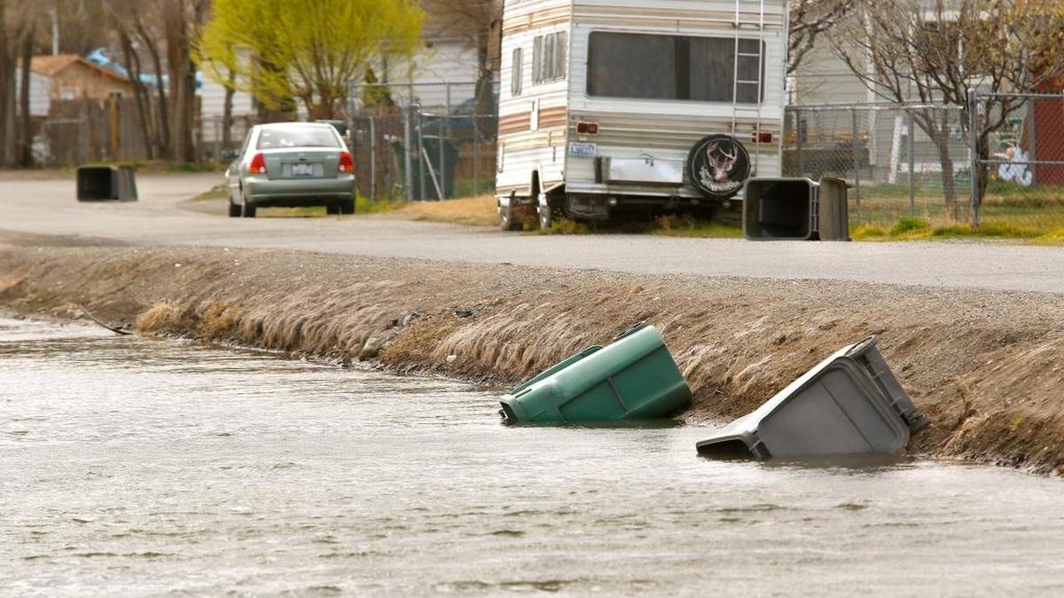 Empty garbage containers on South Alder Street just east of South Washington Street in Kennewick ended up blown on their sides in the roadway or in the Columbia Irrigation District canal during Tuesday's gusty weather.