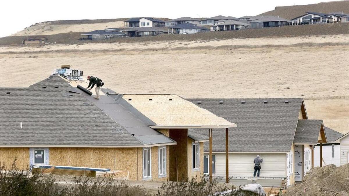 Construction laborers work on new homes Tuesday in a new housing development near West 33rd Place and South Van Buren Street in the Southridge area of Kennewick. Experts say 800 new construction jobs contributed to the 3,500 jobs added last year. The year ended with a 6.7 percent unemployment rate and overall job growth of 3.2 percent.