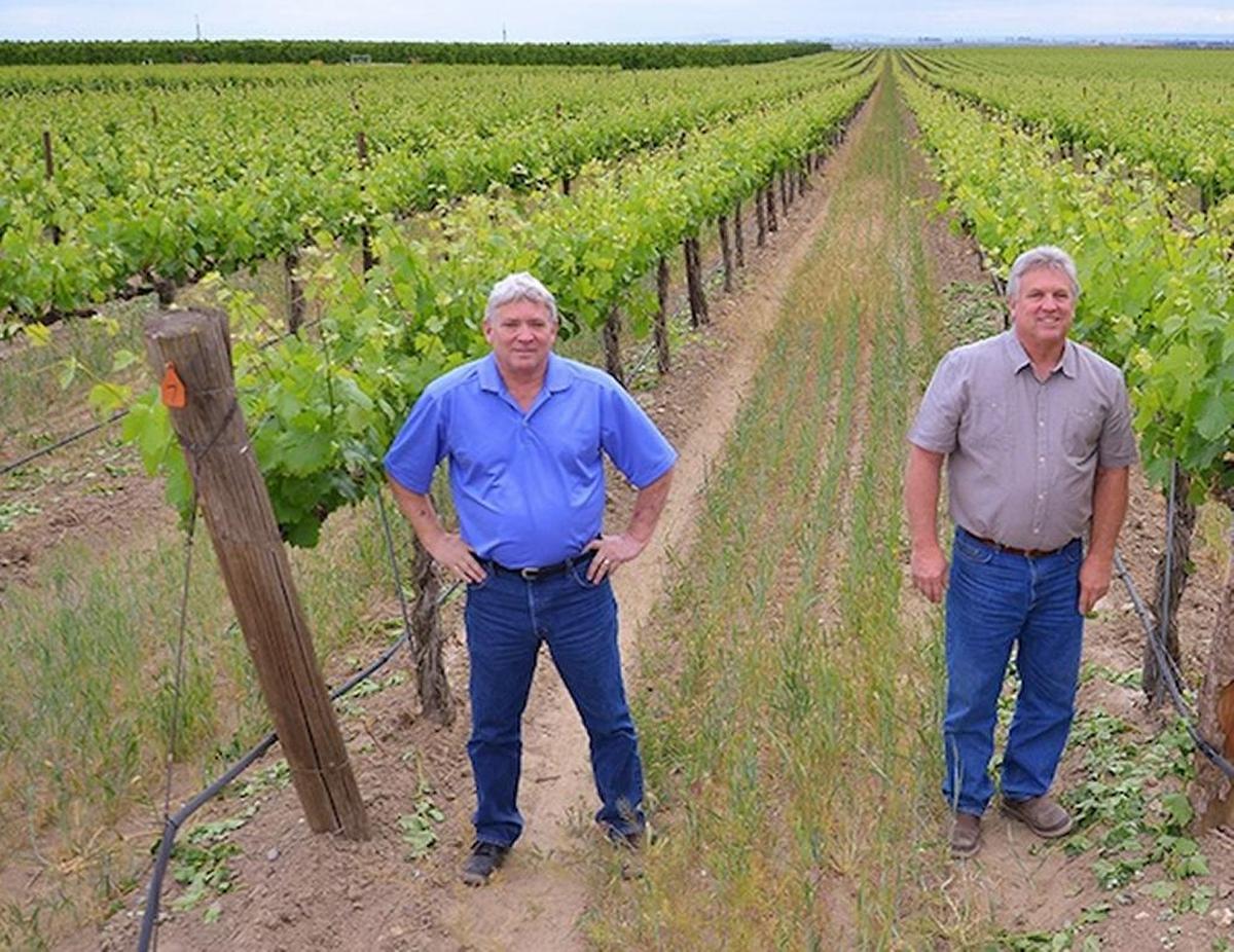 Bob Gamache, left and brother Roger Gamache are pictured in this 2021 file photo following the sale of their Gamache Vintners building and land in the Prosser wine village.
