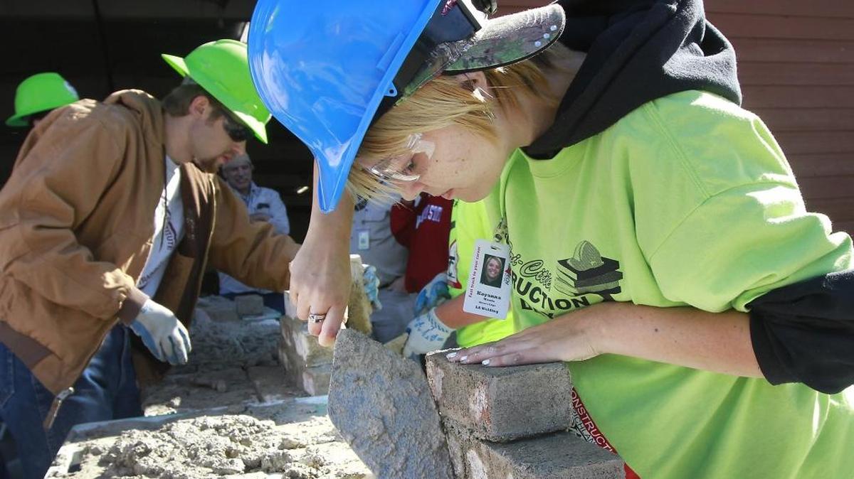Kayanna Morris, a student at River’s Edge High School in Richland, tries her hand Tuesday with brick and mortar at a masonry exhibit at the annual Tri-Cities Construction Career Day at the Benton County Fairgrounds in Kennewick. An estimated 500 area high school students had the chance to learn about career opportunities in construction and construction-related industries. The event is sponsored by the National Association of Women in Construction, the Tri-Cities Construction Council, Tri-Tech Skills Center and numerous local businesses. Watch a video at tricityherald.com/video