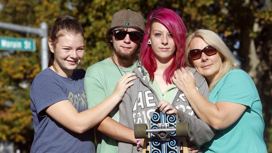 
Beth Striver, 15, second from right, stands with her mother Ann LaRocque, right, younger sister Bonnie Striver, 13, left, and boyfriend Gerald Baugher, 16, with her new longboard at the intersection of Fourth Street and Morain Street in Kennewick. Beth was hit by a car at the intersection last month, and funds from the Kenenwick Police Department’s Community Care fund bought the new longboard to replace the one that was crushed in the collision.
