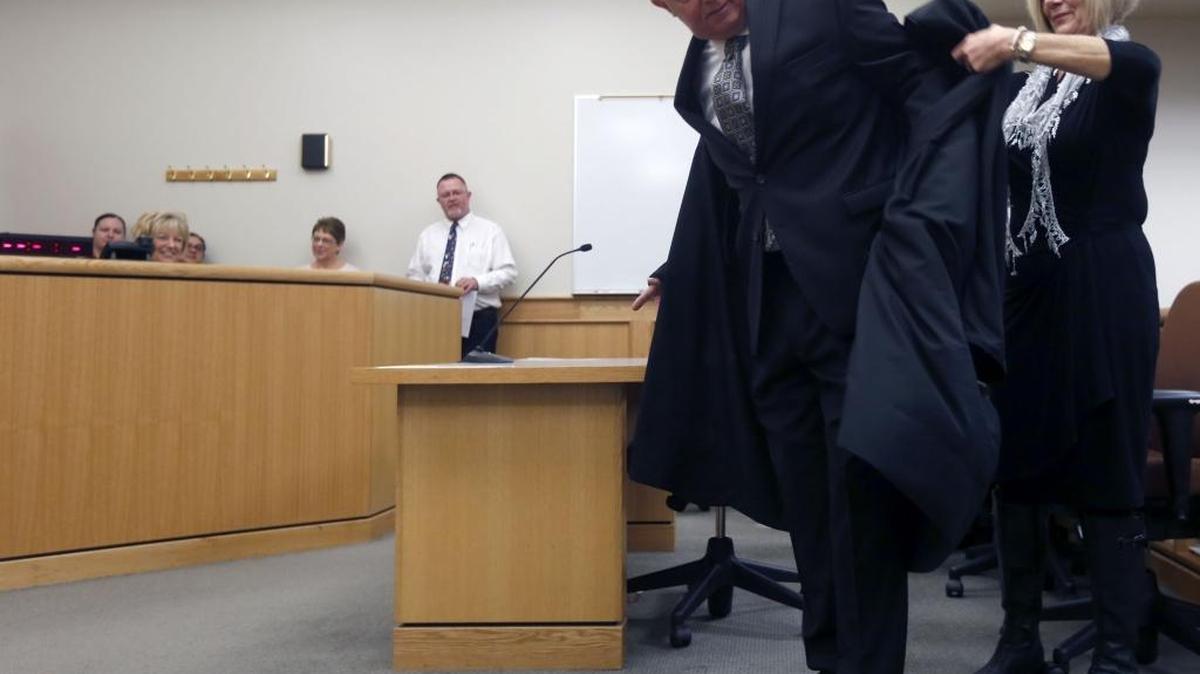Steve Osborne puts on his new robes with help from wife Karen Thursday as he is sworn in as Benton County District Court's newest judge during a ceremony at the Benton County Justice Center in Kennewick. Osborne, a longtime Kennewick lawyer, replaces retired Judge Bob Ingvalson and will run for election next May.