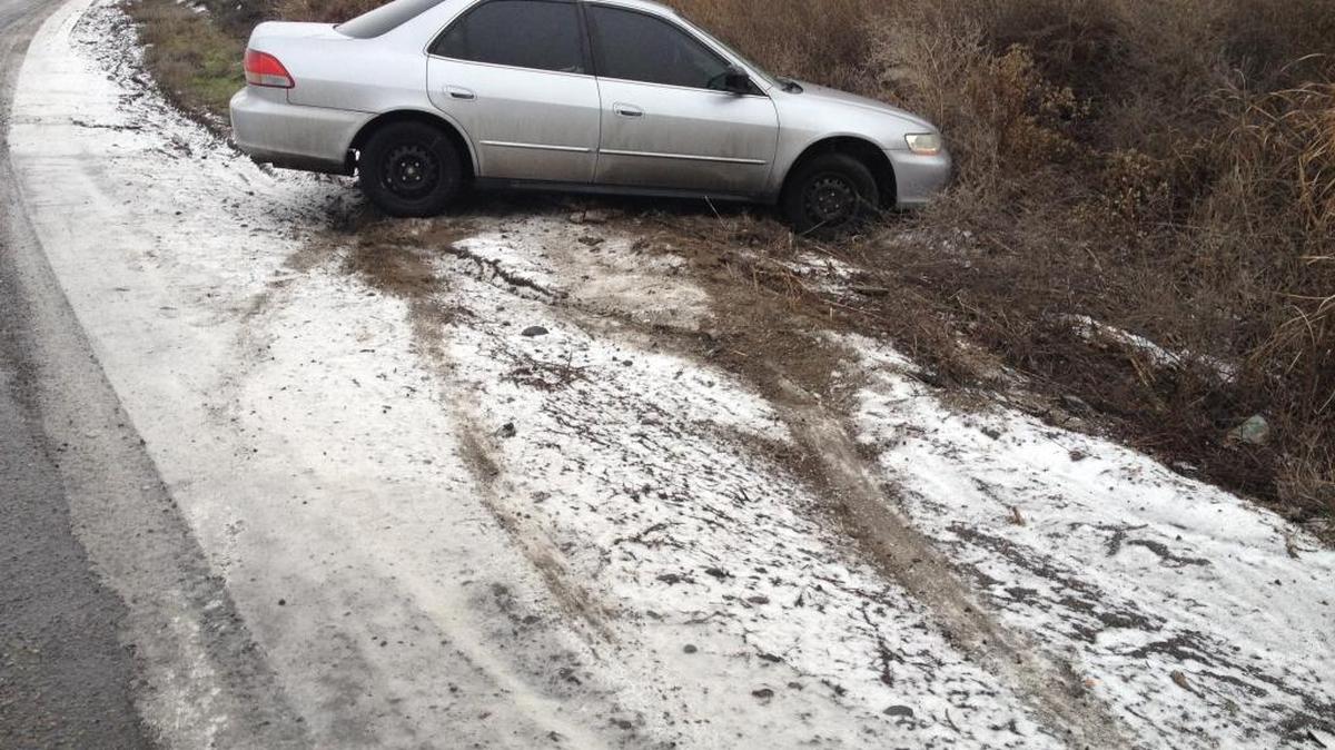 An unoccupied sedan is stuck in the marshy area Wednesday on Selph Landing Road just east of Glade Road North in Franklin County about five miles north of Pasco. It appeared to be non-injury.