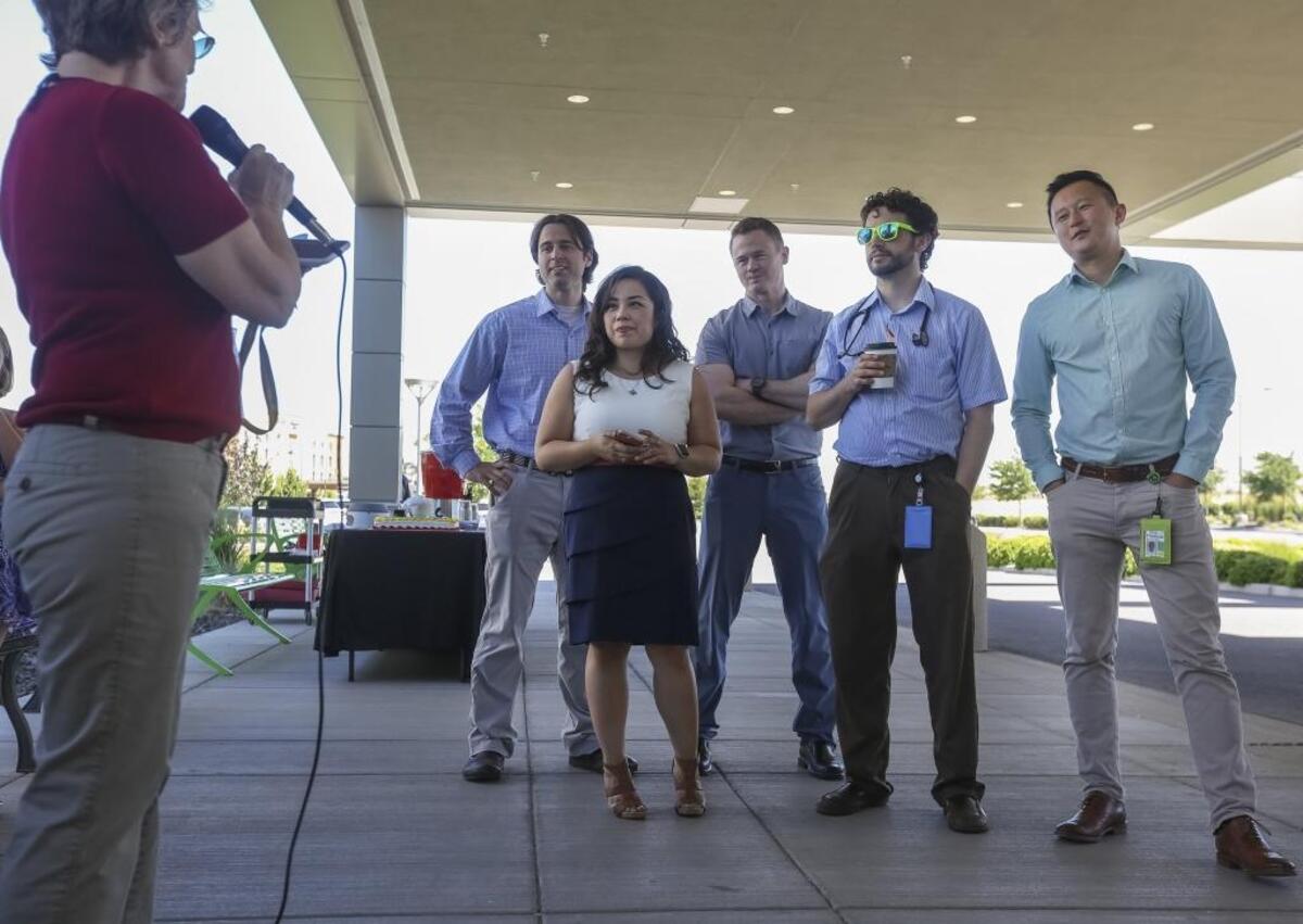 Dr. Sheila Dunlap speaks to Trios Health’s latest graduating class of medical residents on Friday outside of the hospital. Dr. Jeff McDannel, center, is staying in the Tri-Cities and will become a Trios hospitalist.