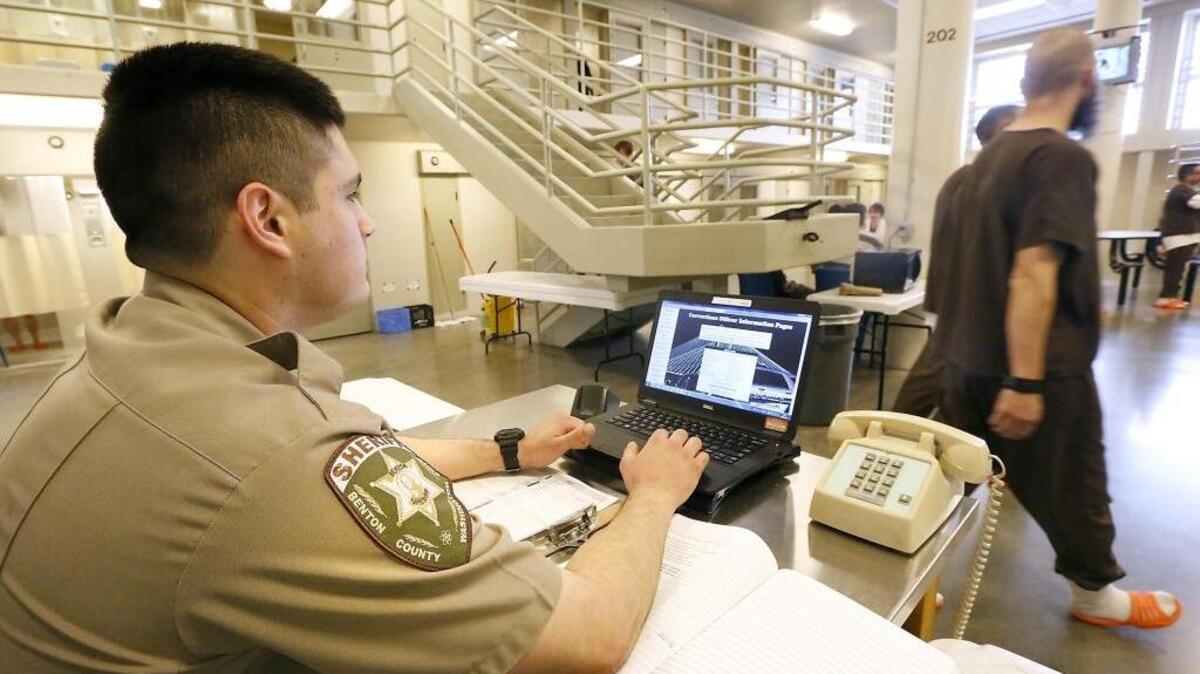 A Benton County Sheriff corrections officer watches over inmates recntly at the Benton County Jail in Kennewick.