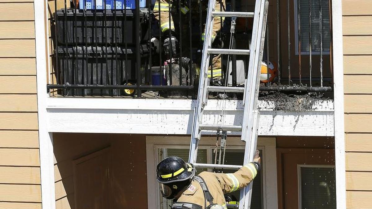 Firefighters from Benton Fire District 4 haul away charred items Monday morning from a second-floor patio at the Quail Springs Apartments on Dallas Road in West Richland. A fire sprinkler on the patio helped extinguish the flames, said Fire Chief Bill Whealan. Damage was limited to the outside of the unit that was empty at the time. Investigators believe the fire started in a potted plant but are still investigating the cause.
