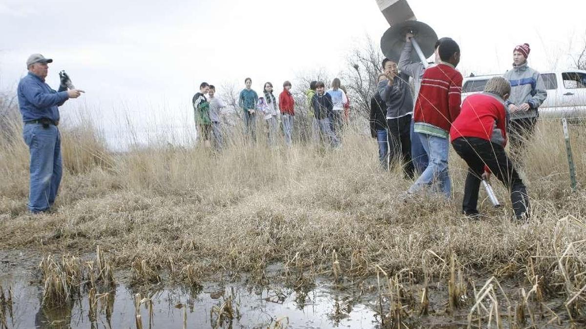 Dale Schielke, left, directs students installing wood duck nesting boxes at Barker Ranch in West Richland as part of a Richland Rod and Gun Club program.