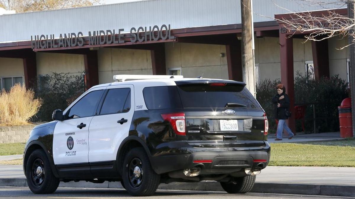 A Kennewick police vehicle is parked outside Highlands Middle School after the building was locked down during an investigation of a potential weapons complaint. A 14-year-old male suspect was taken into custody by the Richland Police Department and interviewed by Kennewick police about the incident.