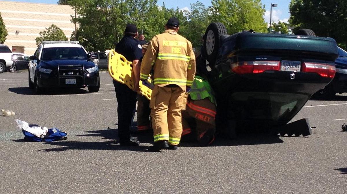 An elderly driver hit a parking island and a planter, rolling his car on its top at the Columbia Center Mall on Monday.