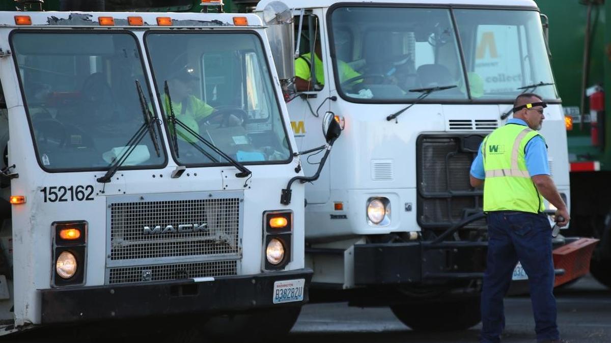Mike Slack, a Waste Management route manager, prepares for morning launch after truck safety inspections and start-ups Aug. 3. Twenty-one drivers participated in special safety and awareness training with Kennewick police to help report any problems or suspicious activity.