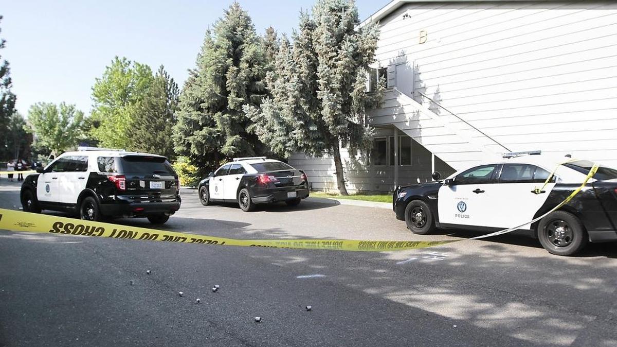 
Kennewick police vehicles are cordoned off with crime scene tape after a SWAT robot discovered Roark K. Cook, 36, of Kennewick, dead inside an apartment in May 2015.
