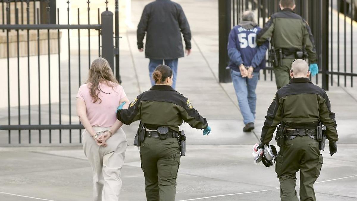 Patricia K. Davidson, left, and Edward E. Reiner, back right, were arrested by sheriff’s deputies Feb. 2 at the Franklin County Courthouse for the alleged theft of money from a veterans emergency assistance fund. Davidson, 60, is serving a six-month sentence in jail after pleading guilty earlier this week to third-degree theft. Reiner, 65, is fighting the charge.