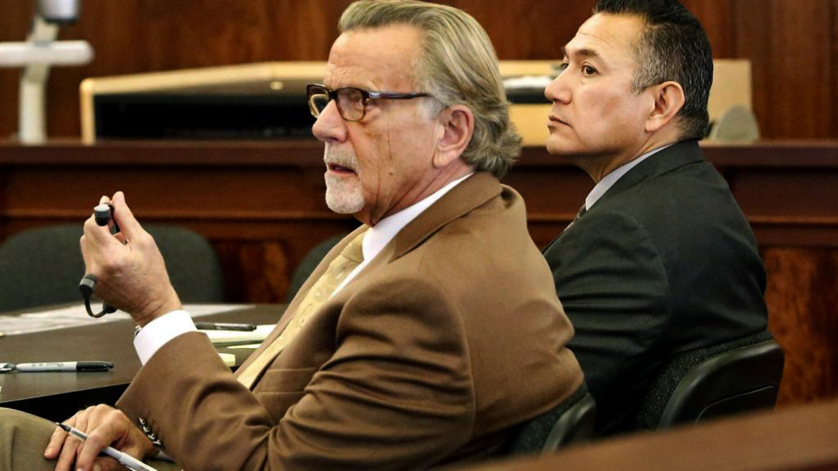 Richard J. Aguirre, right, a former Pasco police officer charged with an off-duty rape and assault of a woman, listens to questions by the Franklin County prosecution in 2017 while seated near his attorney, John Henry Browne. He was later acquitted.