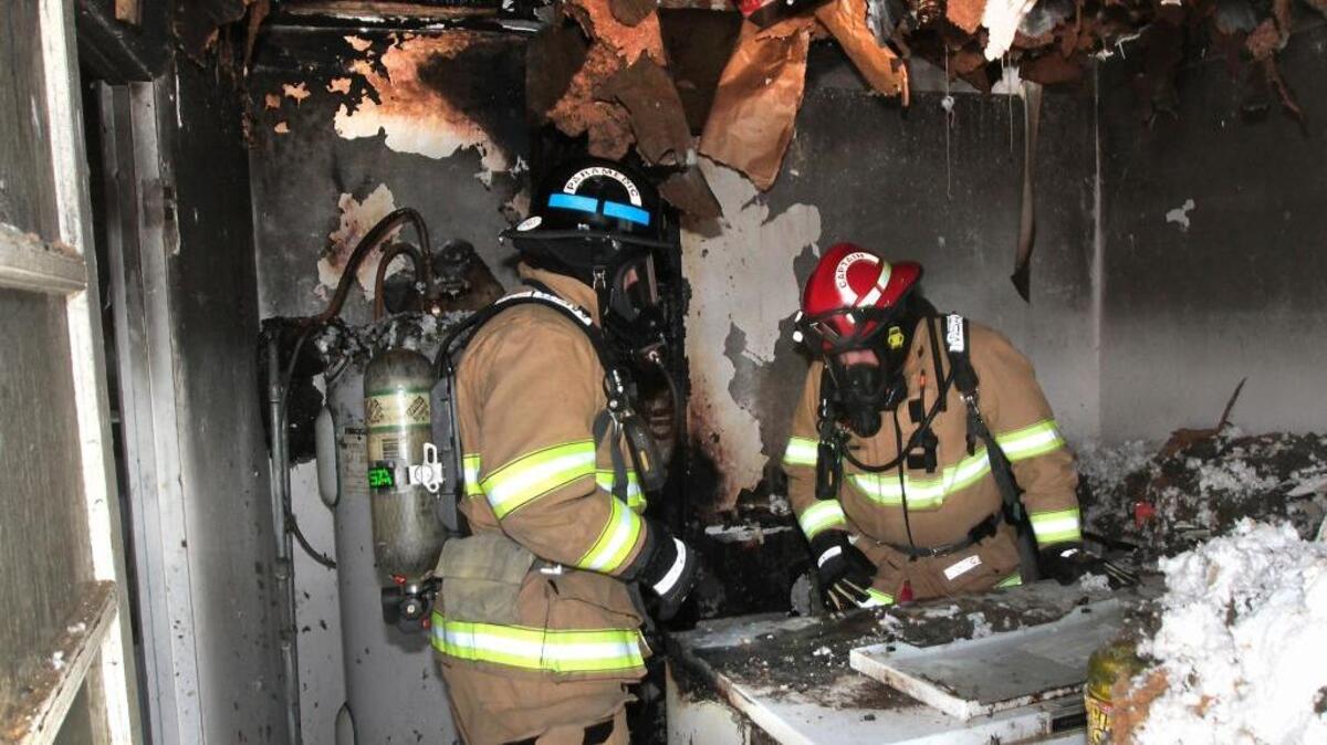 Firefighter paramedic James Longie, left, and Capt. Paul Carlyle search a charred utility room for clues to the cause of an early morning fire Wednesday at 525 Riverside Drive in West Richland. Chief Bill Whealan of Benton Fire District 4 said firefighters saw light smoke at the home when they arrived after being dispatched about 8:40 a.m. The homeowner reported seeing flames near a wall heater and plug-in for the freezer. Firefighters pulled parts of the ceiling and walls down to make sure the fire didn’t spread, but fire damage appeared contained to the utility room. The cause of the fire is still under investigation. No one was injured.