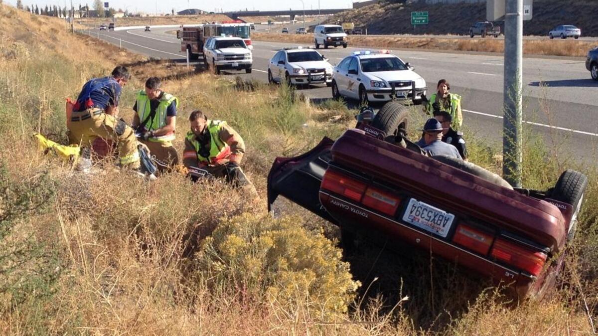 Emergency officials respond to a rollover crash Wednesday morning in the westbound of Interstate 182 near the Broadmoor Road exit.