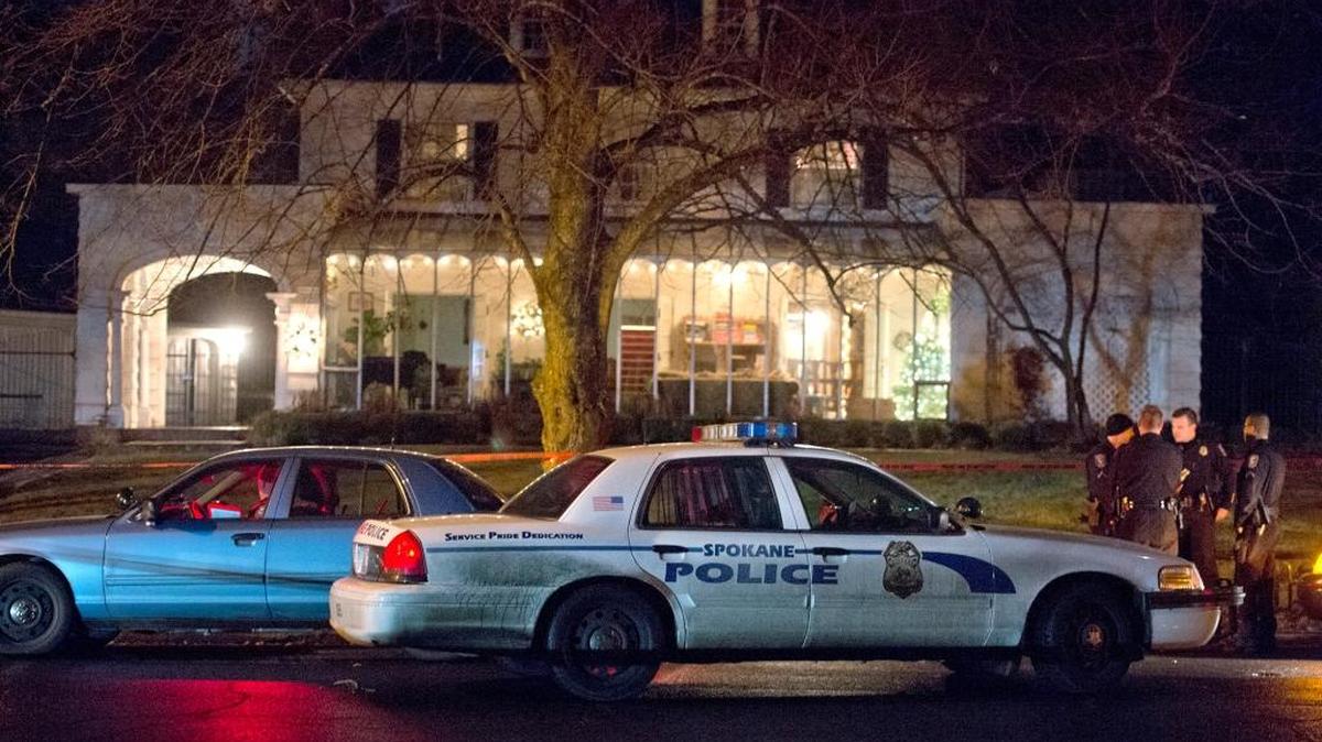 
Spokane police gather outside the home where an intruder shot businessman Doug Carlile on Dec. 15, 2013 in Spokane.

