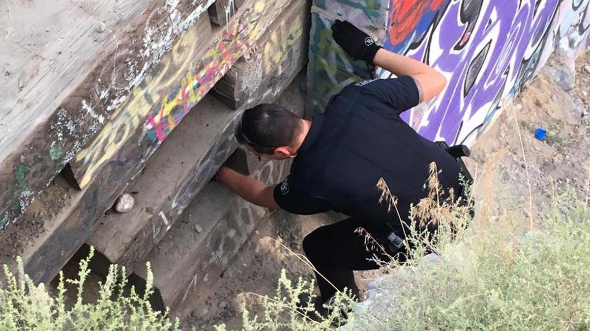 Kennewick police caught two men Tuesday night leaving graffiti on a wall owned by the railroad.