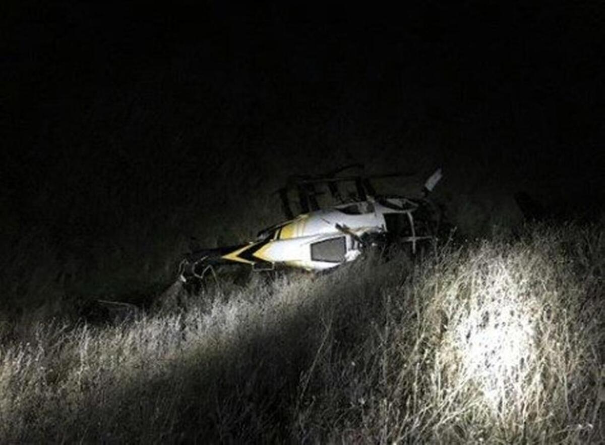 A helicopter is shown after it crashed in Garfield County as it was being used to capture deer Saturday afternoon.