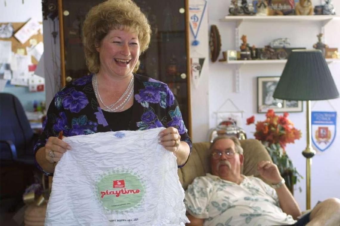 Donna Anderson holds up the T-shirt she was given in 2003 by lottery officials when she claimed the first installment of her $18.2 million Megabucks prize. Her husband, Andy Anderson, right, the former Hermiston police chief, died in 2008.