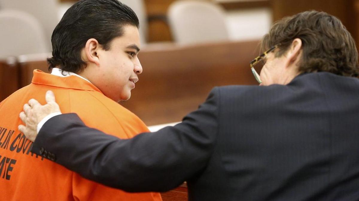 Murder suspect Enrique Alcaide, 22, sits with his attorney Richard Smith during Monday’s hearing in Franklin County Superior Court. Alcaide and his uncle, Santos Flores-Alcaide, were charged in early September with first-degree murder in the shooting death of a Pasco teen outside a dance club.
