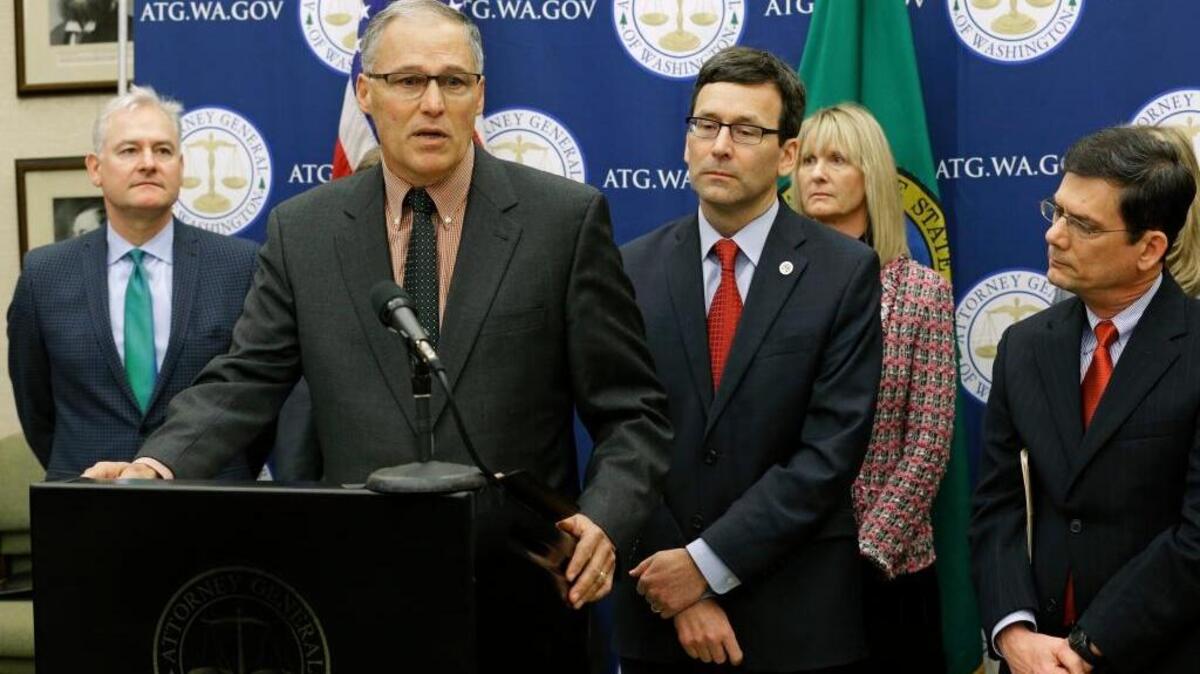 Washington Gov. Jay Inslee, second from left, speaks Monday during a news conference at the Capitol in Olympia to announce that he and Attorney General Bob Ferguson, third from left, have proposed legislation to abolish the death penalty in the state.