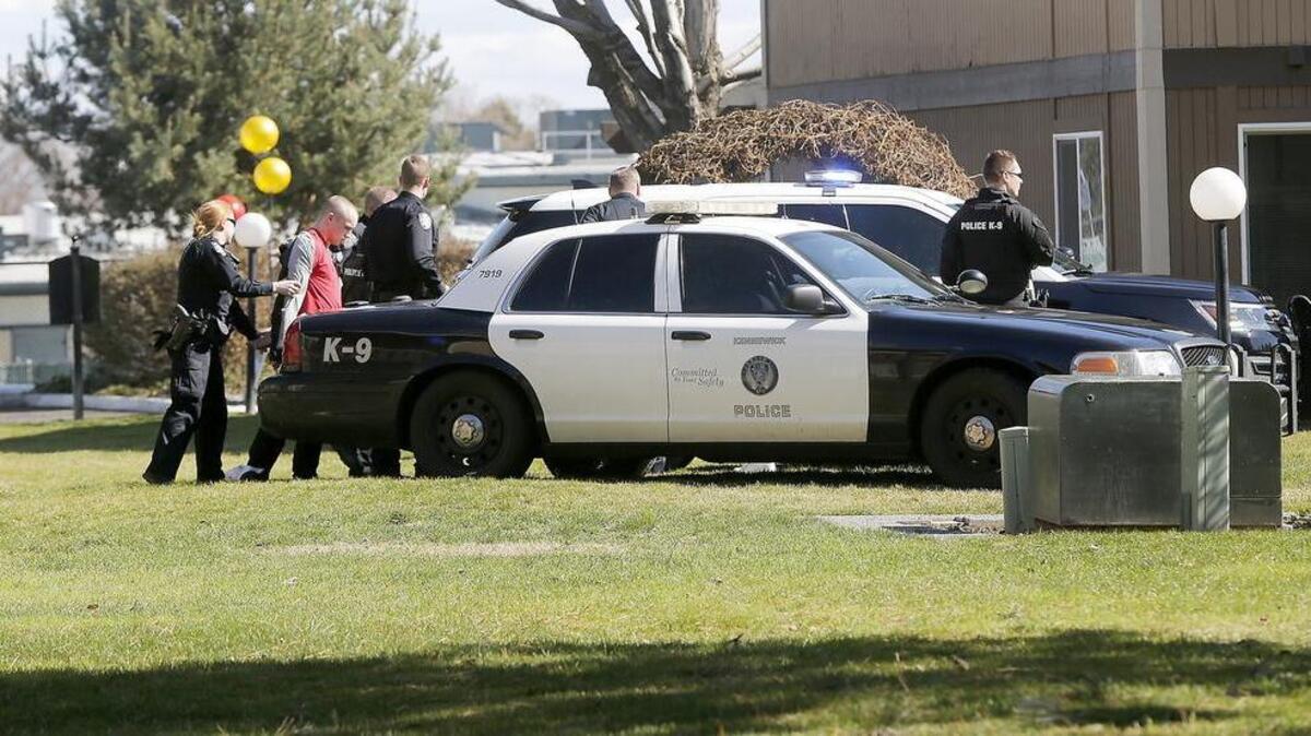 Kennewick Police officers take Leif Hamilton into custody Thursday afternoon following a brief foot chase at the Hawaiian Village Apartments on West 10th Avenue in Kennewick.