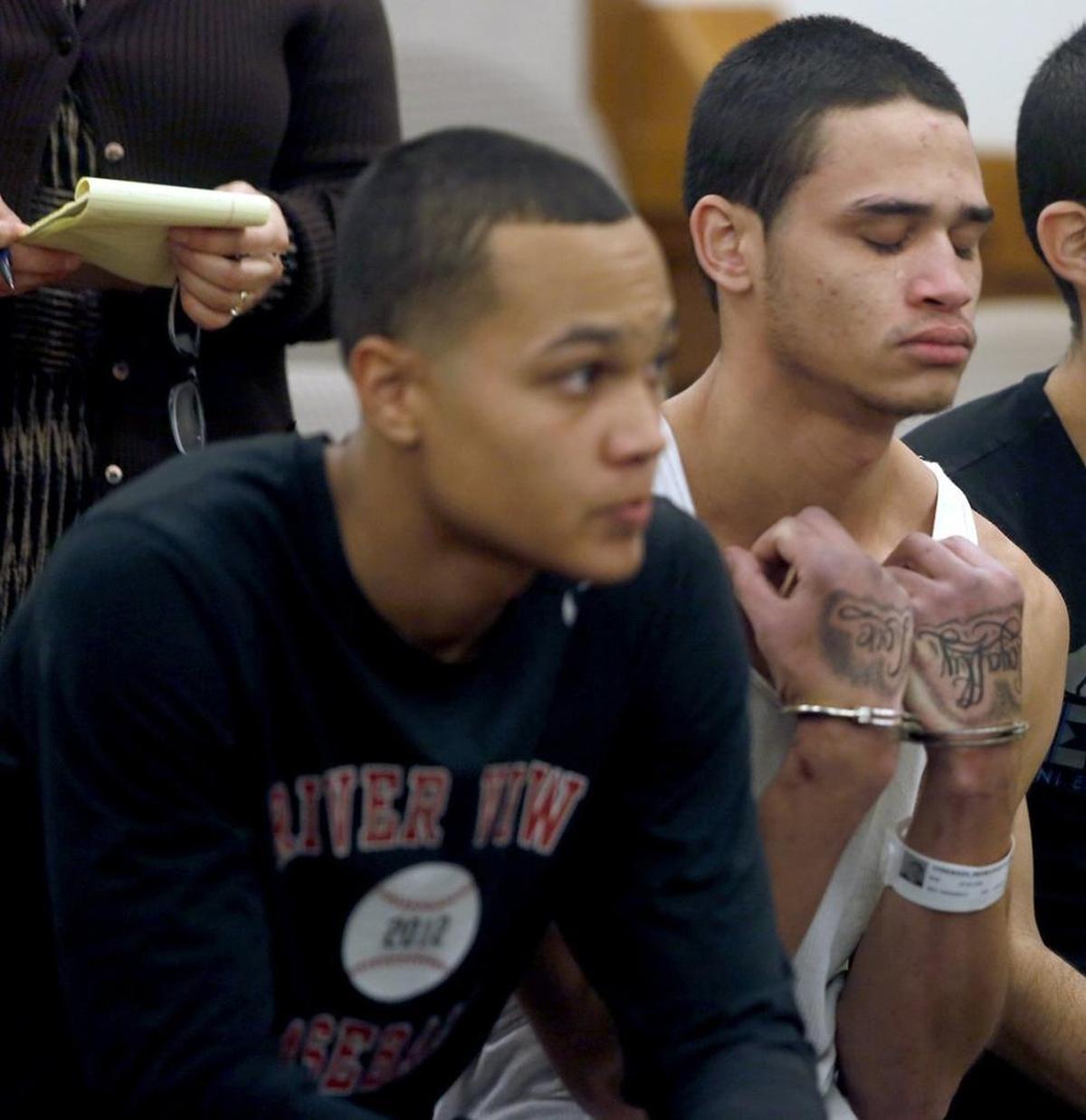 Michael D. Anderson III, left, has been charged with helping his younger brother, DeShawn I. Anderson, right, evade capture for nearly a month during a violent Pasco crime spree in late 2014. DeShawn Anderson, pictured in Franklin County Superior Court after their initial arrests, is serving almost 94 years for murder and multiple assaults.