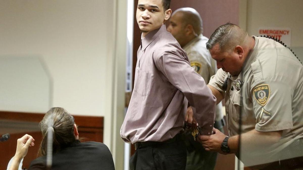 A Franklin County corrections officer takes handcuffs off DeShawn I. Anderson on Monday morning before the start of his trial in Franklin County Superior Court. He is charged in the 2014 shootings that left a Pasco man dead.