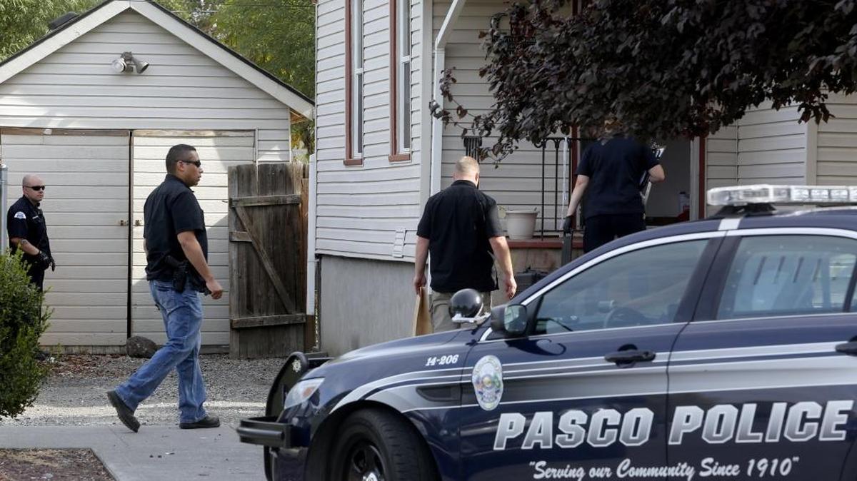 
Officers with the Pasco Police Department search a house in the area of North Sixth Avenue and West Shoshone Street in connection with the death of George Garcia Thacker who was shot Wednesday night. Brothers Nathan T. Quintero, 23, and Jaden F. Quintero, 17, are wanted in connection with the shooting.
