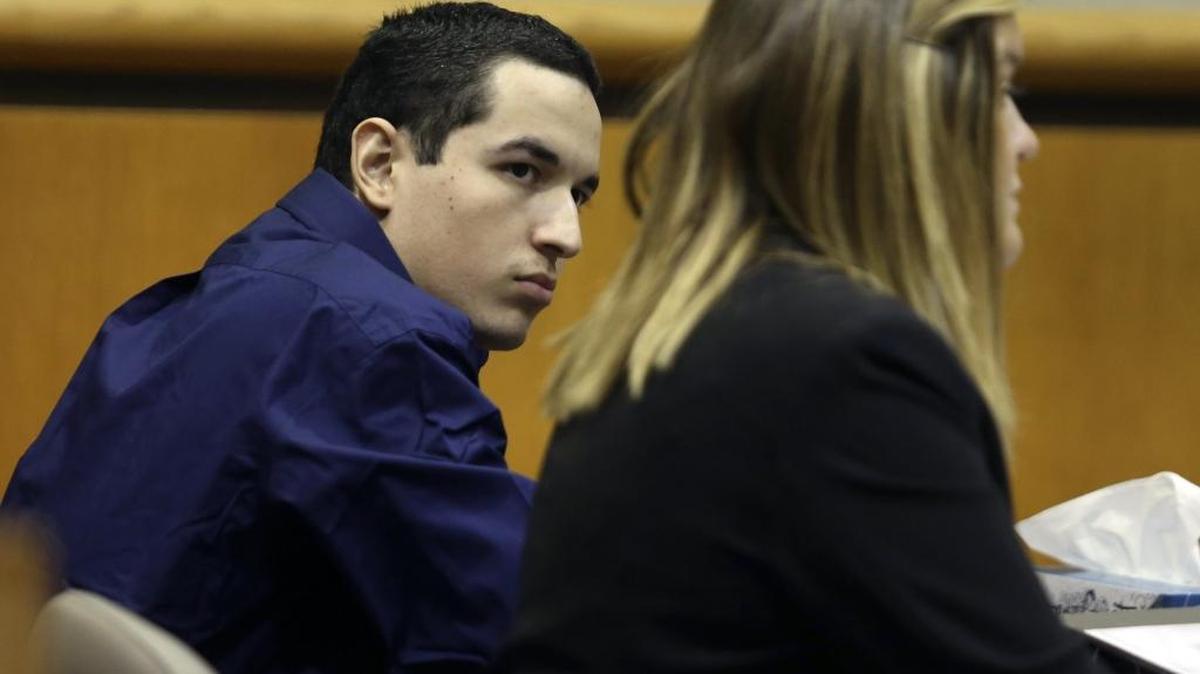 Vincente Figueroa and his defense attorney, Catherine Harkins, talk during his trial.