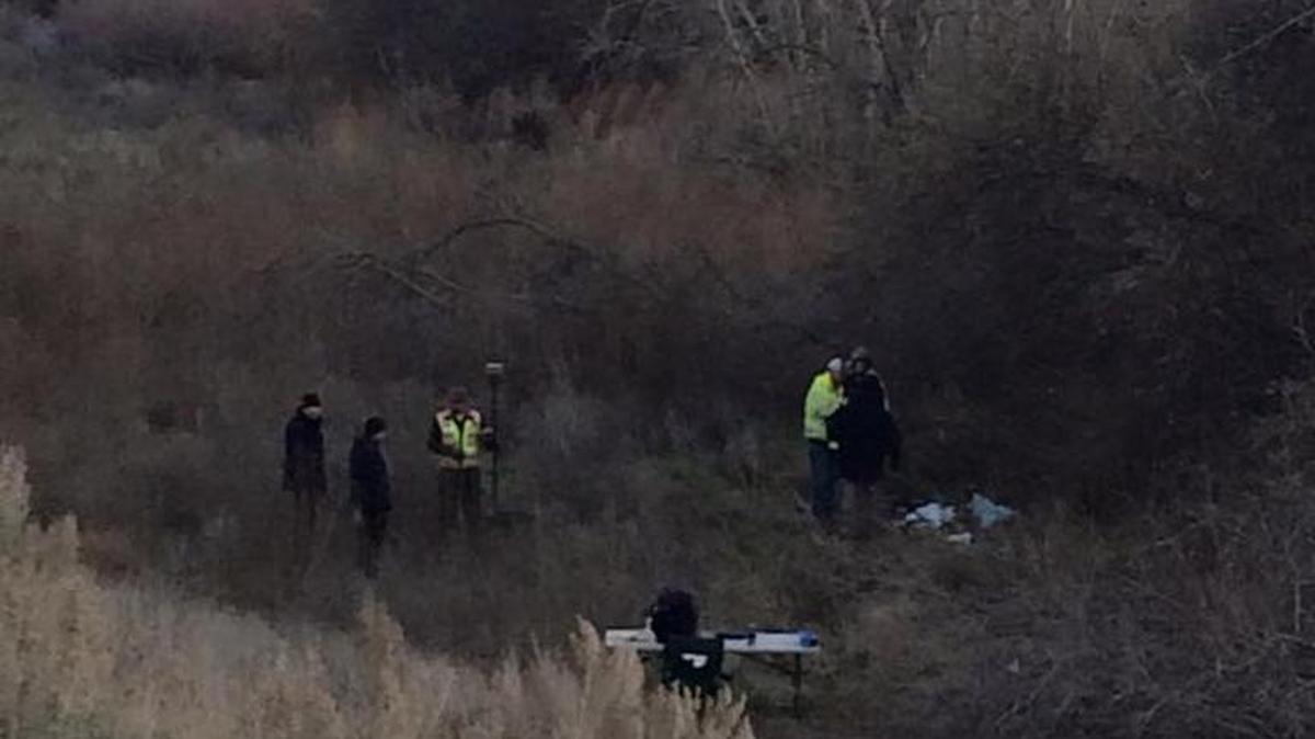 Law enforcement officials process an investigation scene Saturday in Zintel Canyon in Kennewick.