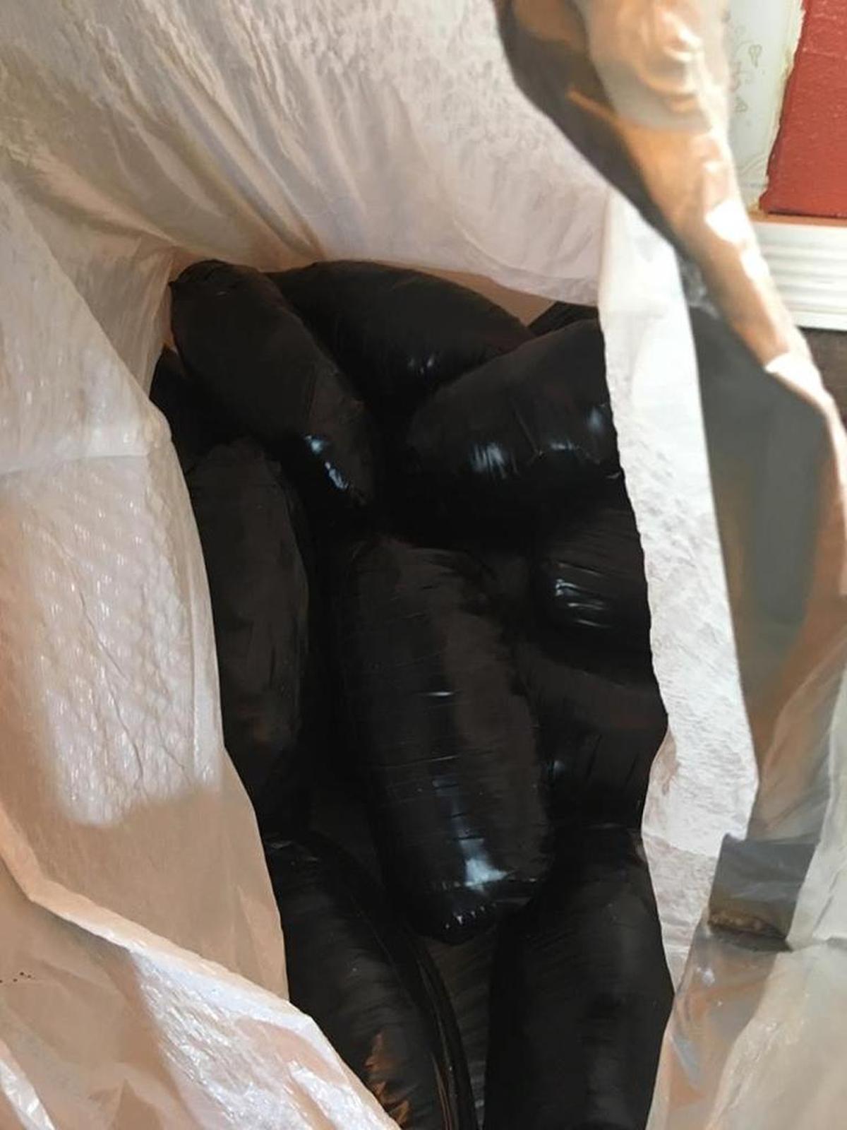 Police show bricks of drugs seized during raids on Thursday.