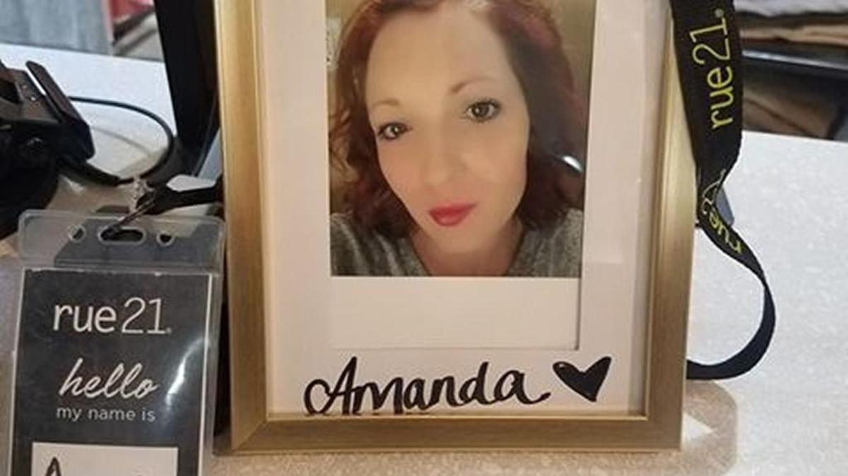 Amanda Hill’s coworkers set up a small memorial for their slain co-worker before releasing balloons Sunday night.