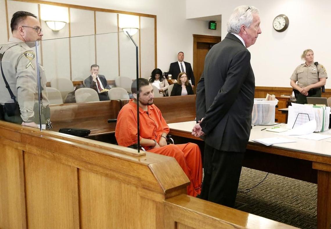 Suspect Edwin Espejo, right, confers with his defense attorney Gary Metro on Tuesday before the start of his arraignment in Franklin County Superior Court. His charges, including attempted murder of three policemen, stem from the Sept. 16 gunfight with Pasco police after they responded to a 911 call.