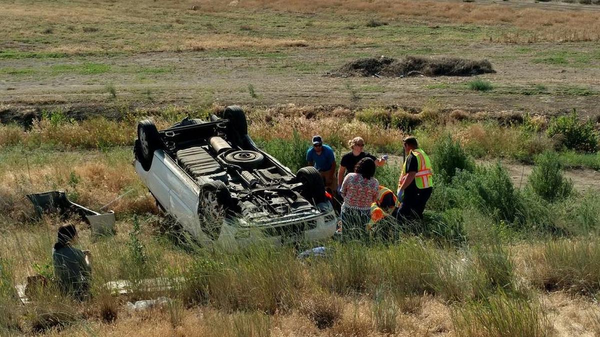 A van lies on its top following a two-vehicle collision on Highway 395 outside of Pasco on Thursday afternoon. Three people were injured in the crash.
