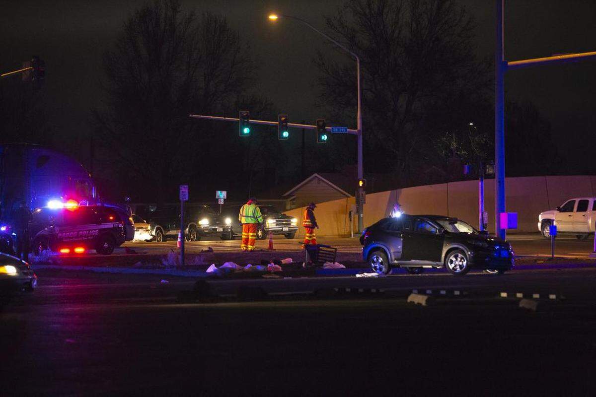 Officers investigate the scene of a crash following a high speed chase on Highway 395 in Kennewick on Saturday.