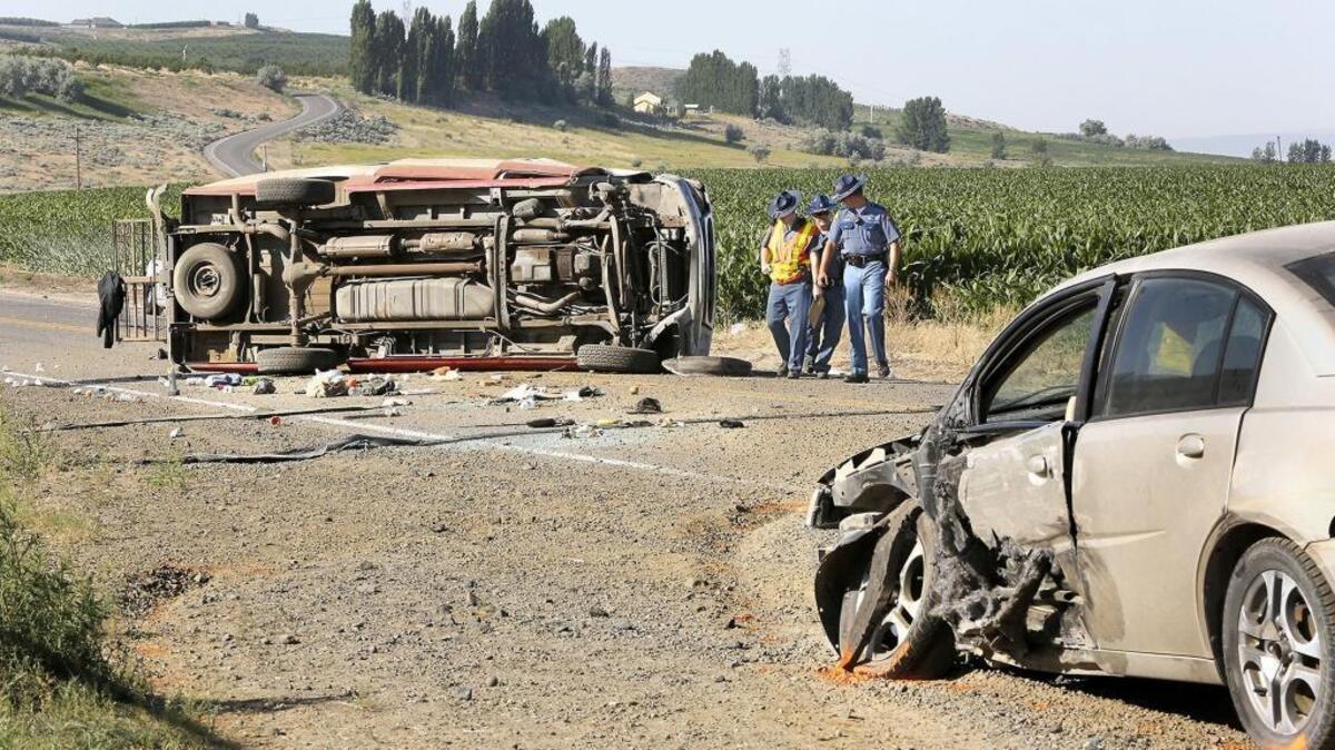 Troopers from Washington State Patrol help investigate the June 16 fatal collision between a Saturn sedan and a full-size Ford van. A 12-year-old boy, Josue Cruz, who was riding in the van being driven by Celernio Leon Martinez was killed. Martinez, 48, is charged with vehicular manslaughter for allegedly causing the death by driving recklessly.